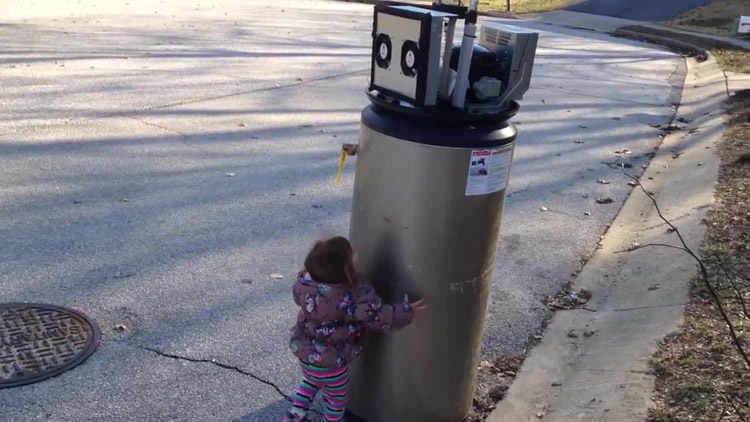 Adorable young girl mistakes water heater for robot 