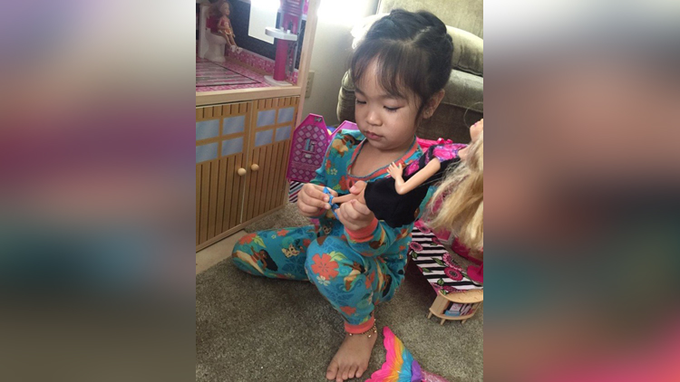 Little girl takes off her Barbies shoes to follow Asian tradition