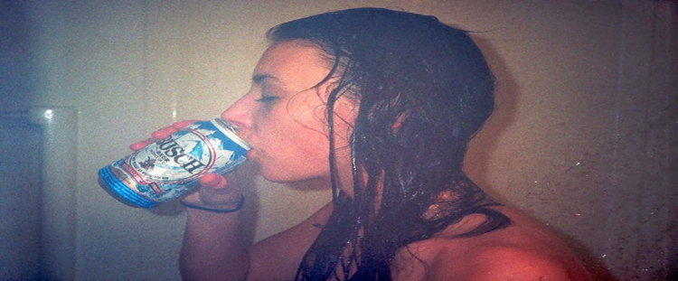girl in shower with beer in hand
