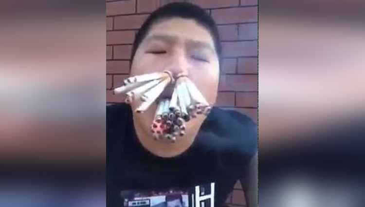 chinese guy eating whole bunch of cigarettes