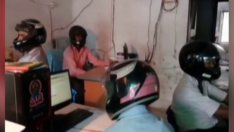 employees of bihar government office wear helmets at work