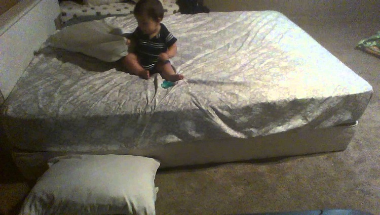 Baby stacks pillows on floor to escape from bed