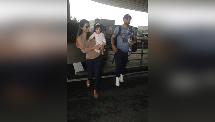 harbhajan singh and geeta basra at mumbai airport with daughter