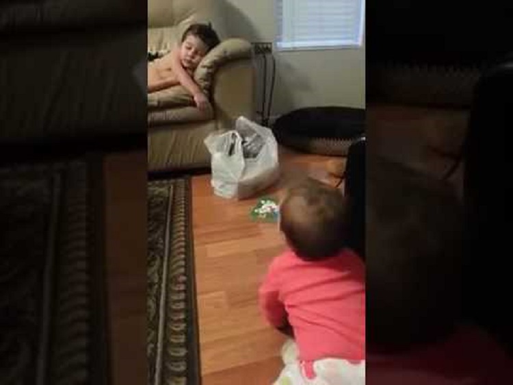Baby sister tries to wake her big brother