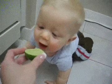 kid eating lemon