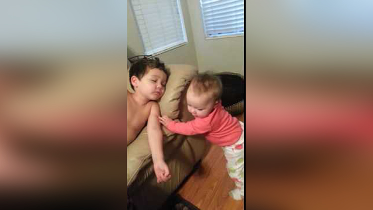 Baby sister tries to wake her big brother