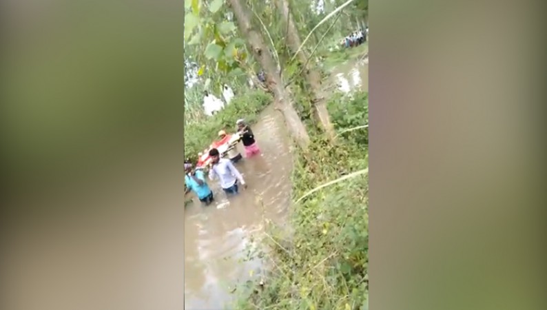 People in pilibhit compelled to cross sewer for last rite Video goes viral