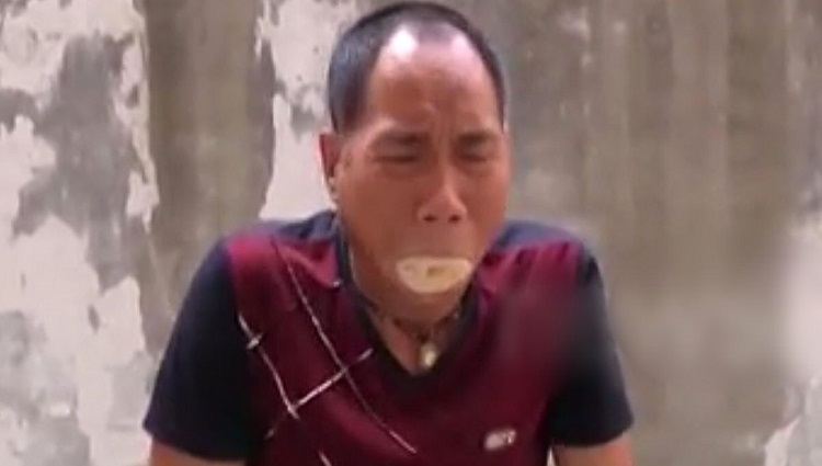 chinese man using sawdust on fire using his mouth